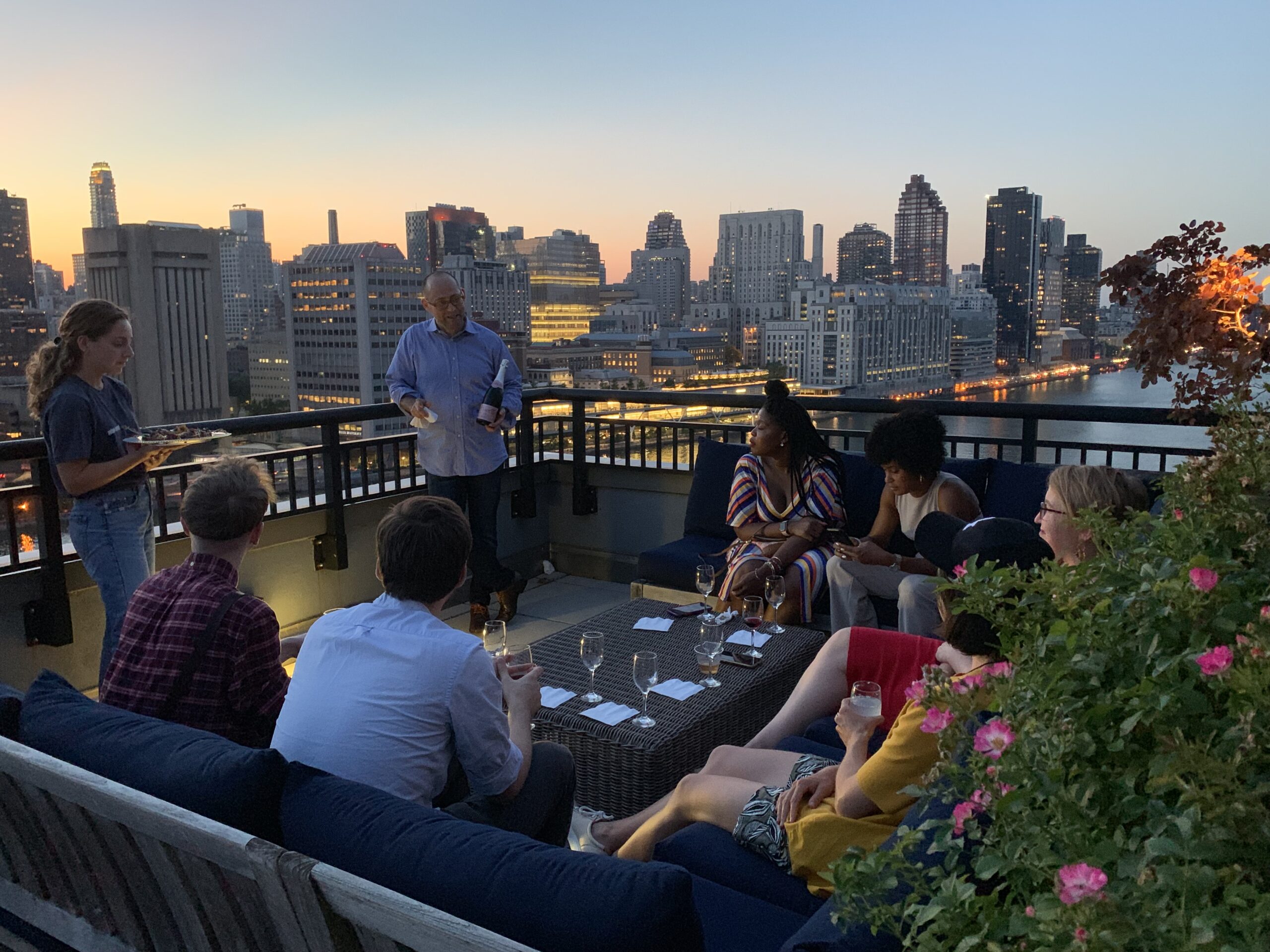 Guests sharing a guided wine tasting around a rooftop table