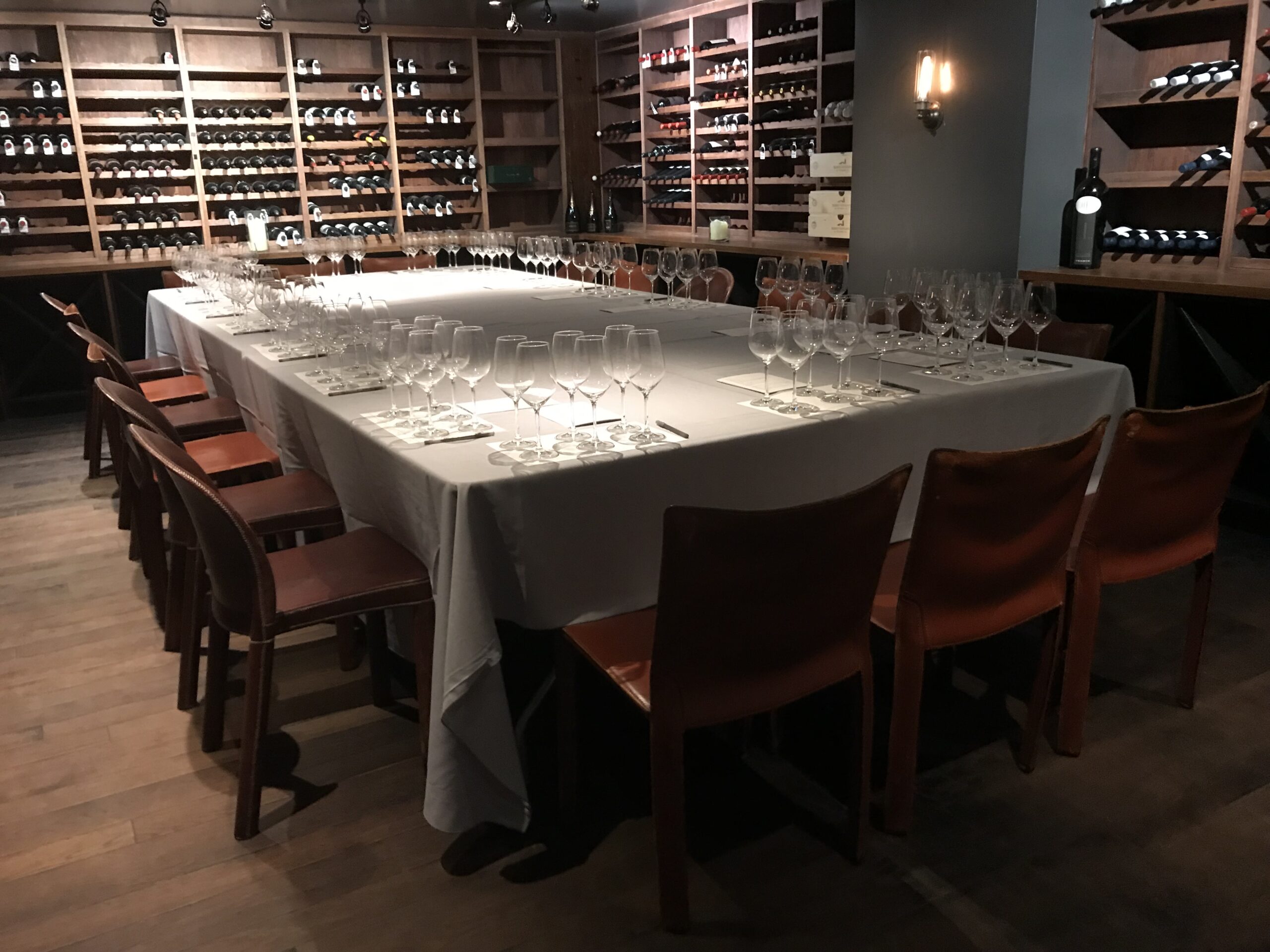 A wine-lined dining room with a table prepared for tasting