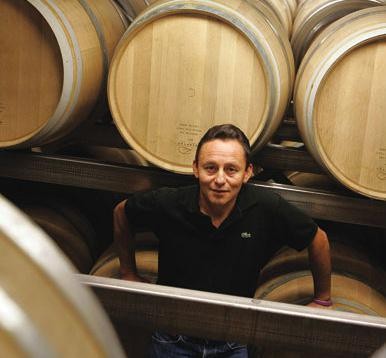 A winemaker among cellar barrels